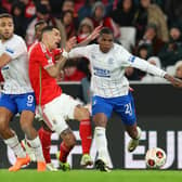 Angel Di Maria of Benfica is challenged by Rangers' Cyriel Dessers and Dujon Sterling