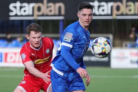 Thomas Maguire in action against Cliftonville's Patrick Burns during Saturday's game at Stangmore Park, Dungannon. PIC: David Maginnis/Pacemaker Press
