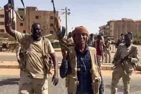 Sudanese paramilitary fighters wave assault rifles cross a street in the East Nile district of Khartoum. The brutality facing the people of Ukraine, and now Sudan, put our concerns in a certain perspective(Photo by -/Rapid Support Forces (RSF)/AFP via Getty Images)