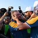 Team Europe's Jon Rahm (R) and Shane Lowry (L) embrace after their victory on the final day of the Ryder Cup in Rome in October