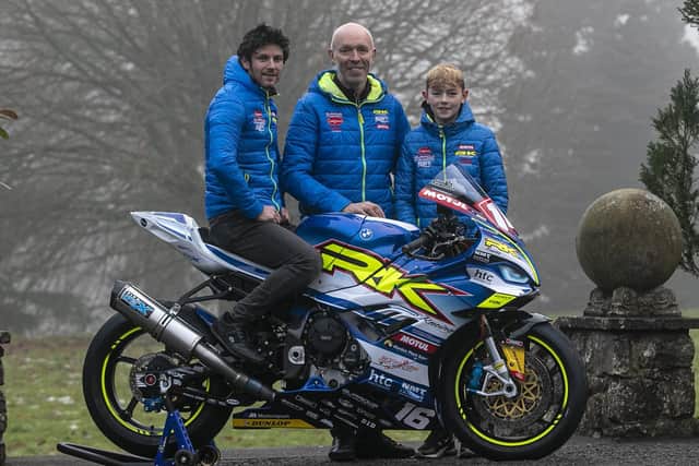 Burrows Engineering/RK Racing team owner John Burrows with his son, Jack - who will again ride in the Moto3 class in the Ulster Superbike Championship next year - and road racer Mike Browne with the new BMW M1000RR for 2023. Picture: Baylon McCaughey