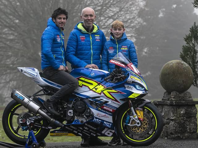 Burrows Engineering/RK Racing team owner John Burrows with his son, Jack - who will again ride in the Moto3 class in the Ulster Superbike Championship next year - and road racer Mike Browne with the new BMW M1000RR for 2023. Picture: Baylon McCaughey