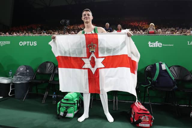 Gymnast Rhys McClenaghan with the Ulster Banner after winning gold at the 2018 Commonwealth Games on the Gold Coast, Australia