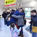 Emotional scenes as families are reunited for Christmas at Belfast City Airport, Northern Ireland. Picture: Arthur Allison/Pacemaker Press.
