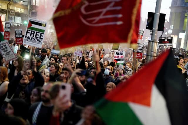 People take part in a Palestine Solidarity Campaign demonstration near the Israeli Embassy, in Kensingston, London. Photo: Jordan Pettitt/PA Wire