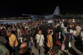 Jordanians evacuated from Sudan arrive at a military airport in Amman, Jordan, Monday, April 24, 2023. (AP Photo/Raad Adayleh)