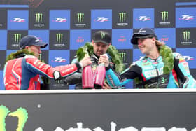 Michael Dunlop celebrates winning the second Supersport race at the 2025 Isle of Man TT from runner-up, Dean Harrison (left) and third-placed Davey Todd. (Photo by Stephen Davison/Pacemaker Press)