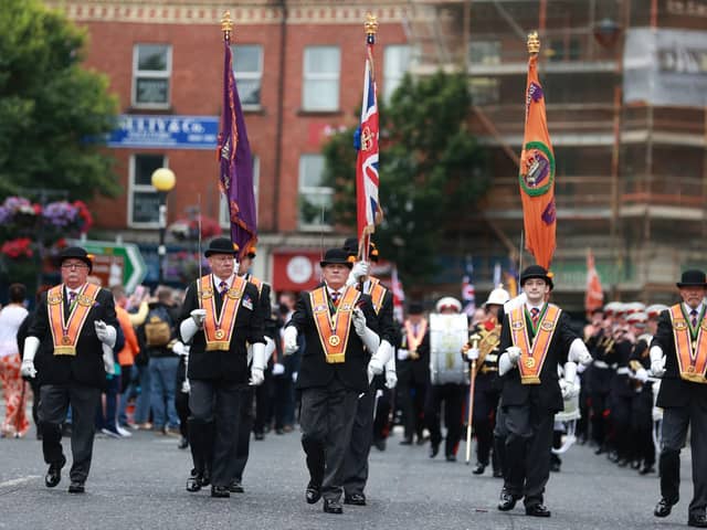 Members of the Orange Order parade in Belfast during the traditional Twelfth commemorations