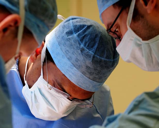 Surgeons performing an operation. Photo: Rui Vieira/PA Wire