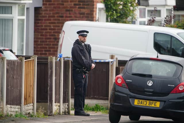 A police officer on duty at the scene in Kingsheath Avenue, Knotty Ash, Liverpool, where a nine-year-old girl has been fatally shot. Officers from Merseyside Police have started a murder investigation after attending a house at 10pm Monday following reports that an unknown male had fired a gun inside the property. Picture date: Tuesday August 23, 2022.
