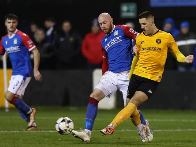 Carrick Rangers forward Nedas Maciulaitis in action against Linfield's Chris Shields. PIC: INPHO/Lorcan Doherty