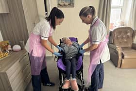 Caoimhe and Samantha help Elizabeth into her bespoke moulded wheelchair