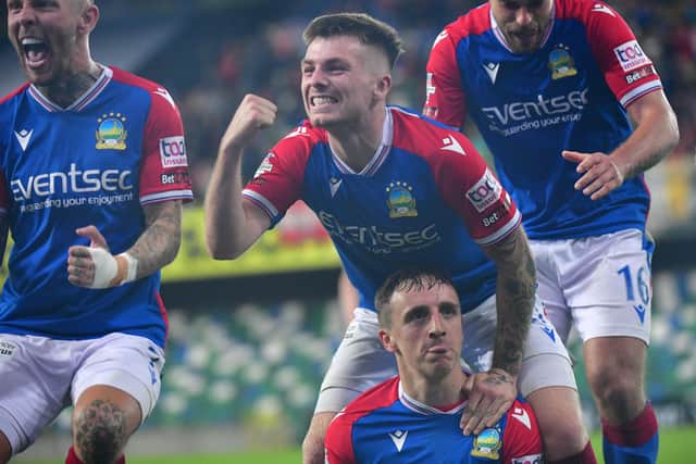 Joel Cooper enjoys the moment as Linfield team-mates celebrate his decisive goal in the Sports Direct Premiership victory over Cliftonville. (Photo by Colm Lenaghan/Pacemaker)