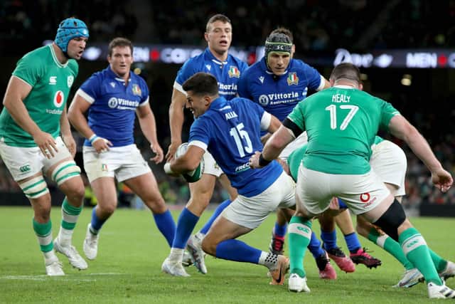 Italy's fly-half Tommaso Allan (C) is tackled during the pre-World Cup Rugby Union friendly match between Ireland and Italy at the Aviva Stadium in Dublin