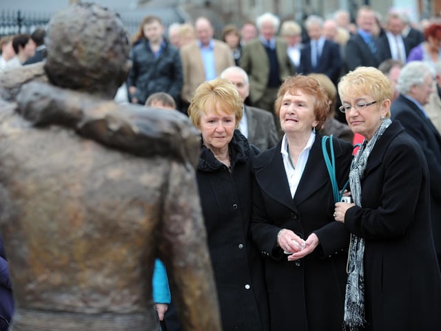 PACEMAKER, BELFAST, 25/3/2011: Robert Dunlop's mother, May is comforted by her daughters Helen and Linda during the unveiling of the statue of Robert in his Memorial Garden in Ballymoney in 2011. Robert lost his life in a crash during practice for the North West 200 in 2008.
PICTURE BY STEPHEN DAVISON:-