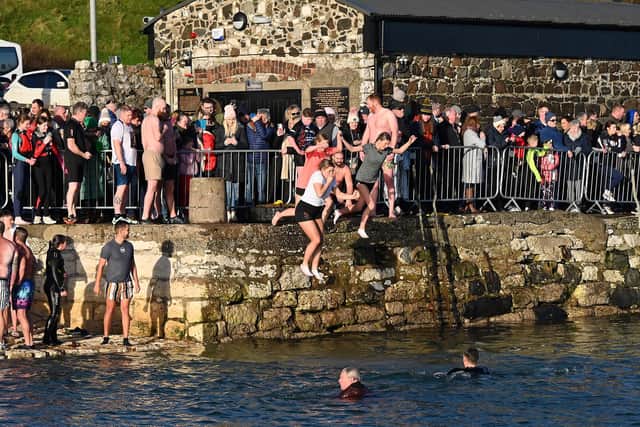 Leaping into 2024 at the annual New Year's Day swim in Carnlough, Co Antrim. Photo: Arthur Allison: Pacemaker Press