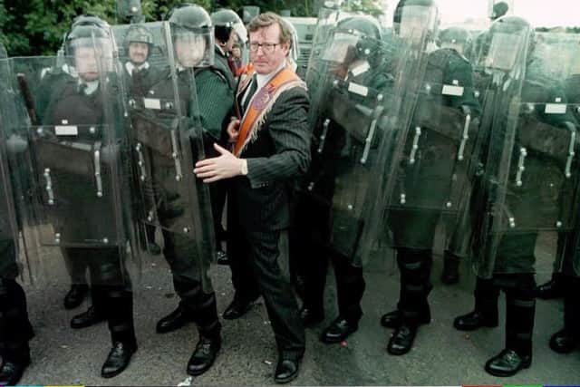 The then UUP leader David Trimble MP squeezes through the RUC line at Drumcree. As London and Dublin recognised, if the 1996 parade hadn’t gone ahead Trimble’s leadership and the peace process would have been over. The UK government saw that, under the sash and the red face, there was a serious strategic intelligence. Photo by Brian Little/PA.