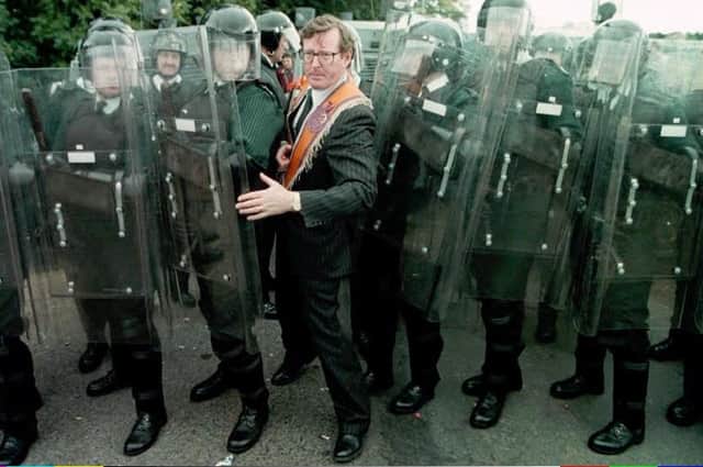 The then UUP leader David Trimble MP squeezes through the RUC line at Drumcree. As London and Dublin recognised, if the 1996 parade hadn’t gone ahead Trimble’s leadership and the peace process would have been over. The UK government saw that, under the sash and the red face, there was a serious strategic intelligence. Photo by Brian Little/PA.
