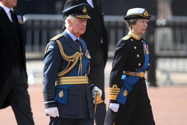 King Charles III and the Princess Royal follow the coffin of Queen Elizabeth II, draped in the Royal Standard with the Imperial State Crown placed on top, is carried on a horse-drawn gun carriage of the King's Troop Royal Horse Artillery, during the ceremonial procession from Buckingham Palace to Westminster Hall, London, where it will lie in state ahead of her funeral on Monday.