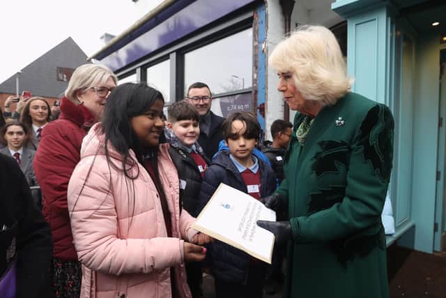 Queen Camilla recieves a message of goodwill during a visit to Lisburn Road in Belfast
