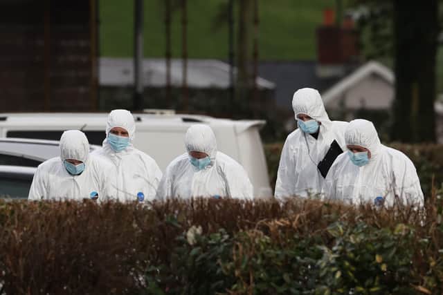 Forensic officers at the scene near the sports complex in the Killyclogher Road area of Omagh, Co Tyrone late last week, after off-duty PSNI Detective Chief Inspector John Caldwell was shot a number of times by masked men in front of young people he had been coaching. Mr Caldwell remains in a critical condition in hospital. Photo: Liam McBurney/PA Wire