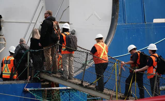 Officials from the Transportation Safety Board of Canada board the Polar Prince after it arrived at the Port of St John’s in Newfoundland, Canada on Saturday