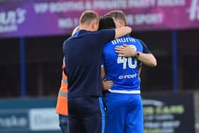 Gerardo Bruna celebrates with Dean Shiels and Tony Gorman after Dungannon Swifts avoided relegation