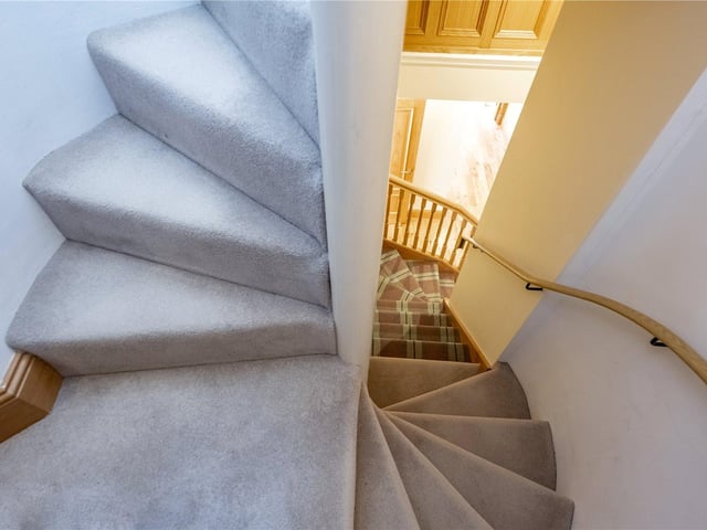Spiral stairs link the apartment's different floors.