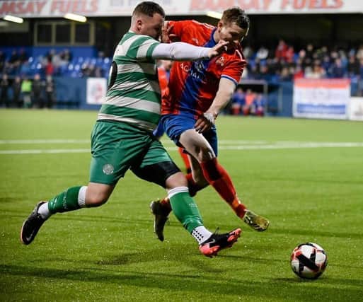 Cleary Celtic striker Declan Monaghan takes on Linclon Court's defender Scott Adair during the Junior Cup semi-final at Dungannon