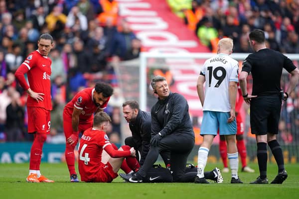 Liverpool's Conor Bradley receives treatment for an injury during the Premier League match at Anfield, Liverpool. PIC: Peter Byrne/PA Wire