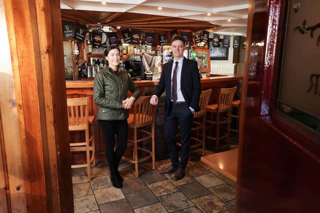 Husband and wife duo Michael and Aveen Moreland have taken over ownership of Minny Doyle’s, the popular traditional Irish pub in Hilltown once owned by Aveen’s family, as part of a six-figure investment. Pi ctured is Ulster Bank business development manager Lee White with new owner of Minny Doyle’s pub in Hilltown, Aveen Moreland