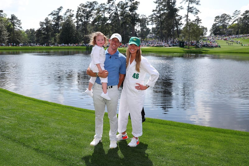 AUGUSTA, GEORGIA - APRIL 05: Rory McIlroy of Northern Ireland poses for a photo with his wife, Erica Stoll and daughter Poppy McIlroy during the Par 3 contest prior to the 2023 Masters Tournament at Augusta National Golf Club on April 05, 2023 in Augusta, Georgia. (Photo by Andrew Redington/Getty Images)