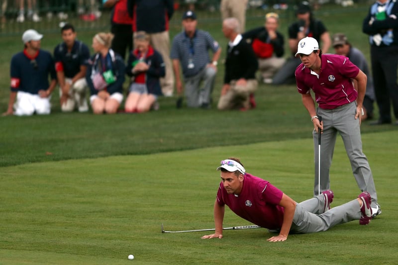 Ian Poulter and Rory McIlroy line up a putt on the 18th hole during day two. (Photo by Andy Lyons/Getty Images)