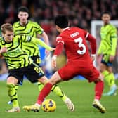 Arsenal's Martin Odegaard challenged by Cody Gakpo (left) and Wataru Endo in the Premier League draw with Liverpool at Anfield. (Photo by Stuart MacFarlane/Arsenal FC via Getty Images)