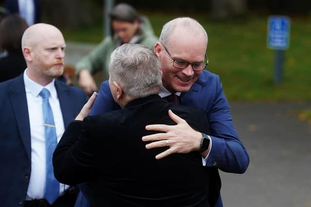 Irish Foreign Affairs Minister Simon Coveney (right) embraces Fr. Gary Donegan as he arrives to speak at a John & Pat Hume Foundation event at the Houban Centre in Belfast. Minister Coveney who earlier this year was forced to evacuate from the peace building event after a bomb threat returned to complete his interrupted speech. Picture date: Wednesday October 19, 2022. PA Photo. See PA story ULSTER Coveney . Photo credit should read: Brian Lawless/PA Wire
