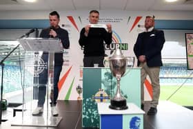 Aaron Hughes (middle) helped to conduct the draw for this year's SuperCupNI tournament