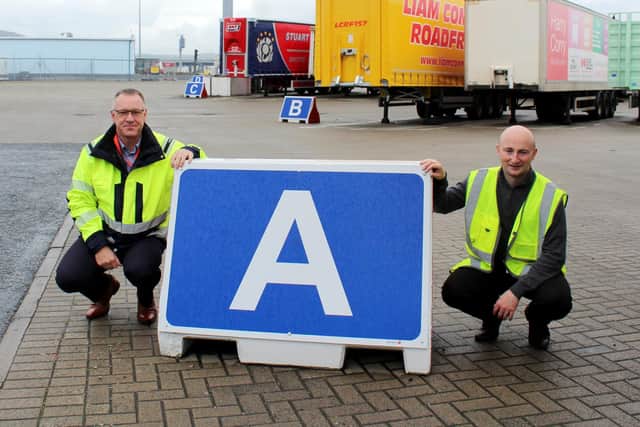 Ballymena's Moore Concrete creates bespoke barrier unit to help ensure safe passage of almost 500 lorries everyday at Cairnryan terminal. Pictured are Stena Line's operational manager Stephen Petticrew and Moore Concrete's Conal McMahon with one of the precast lane indicators, recently installed at the Belfast port