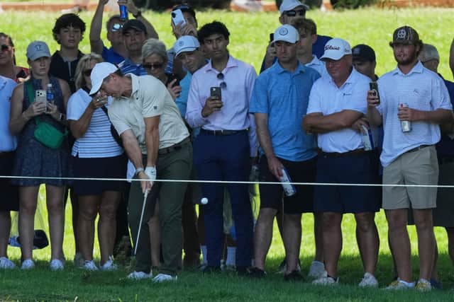 Rory McIlroy hits from the rough on the seventh hole during the first round of the BMW Championship