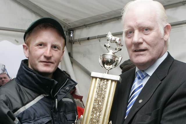 Michael Gallagher accepts his prize from Brian Duffin from Grow at the international sheep dog presentation of prizes at McQuillan's farm Masserene Antrim. Picture: Steven McAuley/Kevin McAuley Photography Multimedia