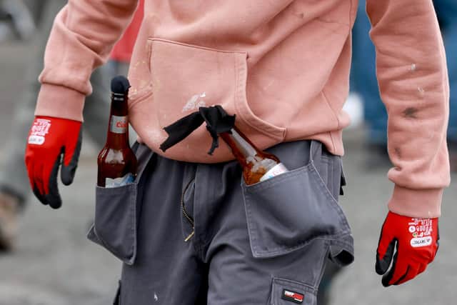 A young man carrying petrol bombs in his trouser pockets at the start of an Easter Monday parade in the Creggan area of Londonderry, commemorating the anniversary of the Easter Rising Rebellion of 1916. Picture date: Monday April 1, 2024. PA Photo. See PA story ULSTER Parade. Photo credit should read: Liam McBurney/PA Wire