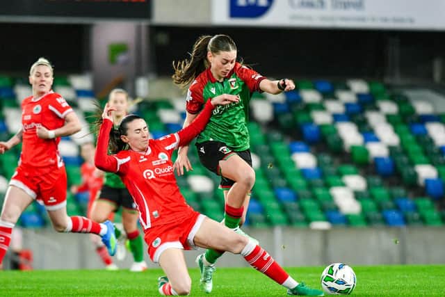 Cliftonville's Toni-Leigh Finnegan sliding in to tackle Naomi McLaughlin during Women's Challenge Cup defeat against Glentoran. (Photo by Andrew McCarroll/Pacemaker Press)