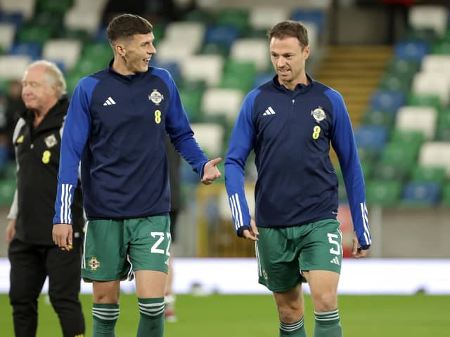 Northern Ireland's Eoin Toal (left) will have another chance to add to his international caps in the absence of injured Manchester United defender Jonny Evans (right)