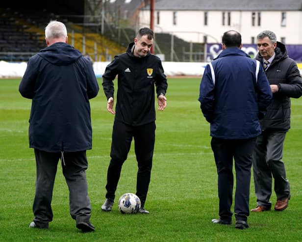Referee Don Robertson (second left) speaks with Dundee and Rangers officials following a pitch inspection resulting in the cinch Premiership match being called off at Tannadice Park, Dundee.