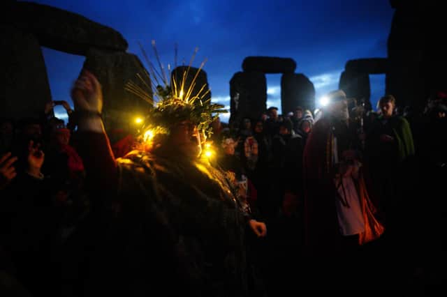 People take part in the winter solstice celebrations at the Stonehenge prehistoric monument on Salisbury Plain in Wiltshire today, the shortest day, Friday December 22, 2023. Ben Lowry wishes he could join them. But not when they return in June ... Photo: Ben Birchall/PA Wire