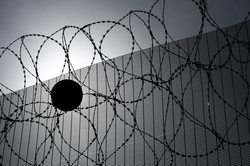 Sport in Prisons. A football is caught in the wire outside Davis House at Maghaberry prison. Picture: Michael Cooper:-
