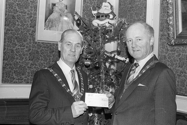 Mr David Robertson, president of the Belfast Chamber of Trade, presenting a £2,000 cheque towards the cost of the fireworks display at Belfast City Hall in December 1982 to the Lord Mayor, Councillor Thomas Patton. Earlier Councillor Patton had toured the city centre and talked to shoppers. Picture: News Letter archives