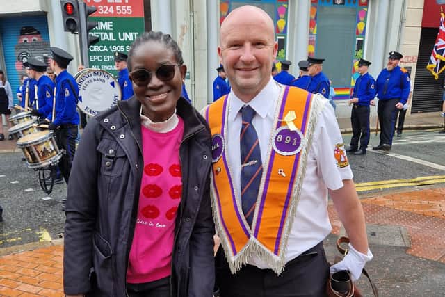 Favour Okpohs, a Nigerian student at Ulster University, poses for a picture with Orangeman Mark Davison from LOL 891