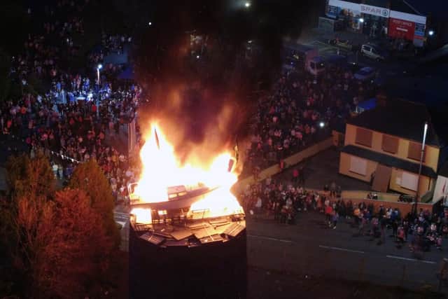 People watch as the pyre with a boat on top is set alight in Moygashel near Dungannon, Co Tyrone. Picture date: Saturday July 8, 2023. Photo credit: Niall Carson/PA Wire