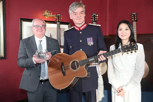 Iain Wilson, founder and managing director of IBC Music was awarded the distinctive crystal trophy by HM Lord-Lieutenant of County Down, Gawn Rowan Hamilton, ahead of launching Titanic Guitars. Also pictured is Iain's wife Connie Wilson, finance director for IBC. IBC was one of 148 organisations nationally to be recognised with the prestigious King's Award for strong growth in international trade and one of only three companies in Northern Ireland