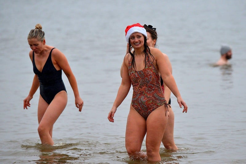 Swimmers brave the elements to take part in the annual Christmas morning charity swim at Ludden beech